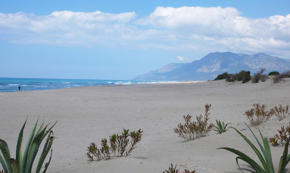 Beautiful soft sand, blue seas and mountains in background at Patara beach